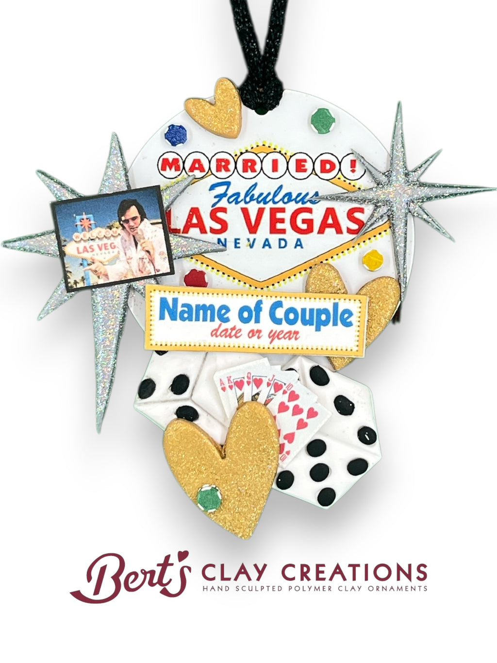 Hand-sculpted polymer clay ornament featuring the “Married! Fabulous Las Vegas” sign, gold glitter hearts, dice, and customizable name/date plaque. Designed by Bert’s Clay Creations.