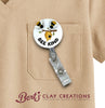 Badge holder with bee design attached to a beige shirt, featuring 'Bert's Clay Creations' logo.