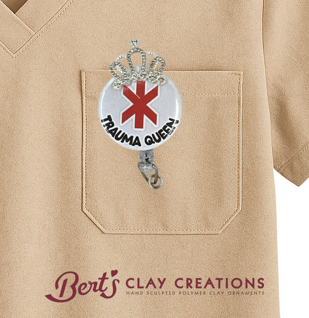 Badge holder with 'Trauma Queen' design on a beige shirt, featuring Bert's Clay Creations branding.