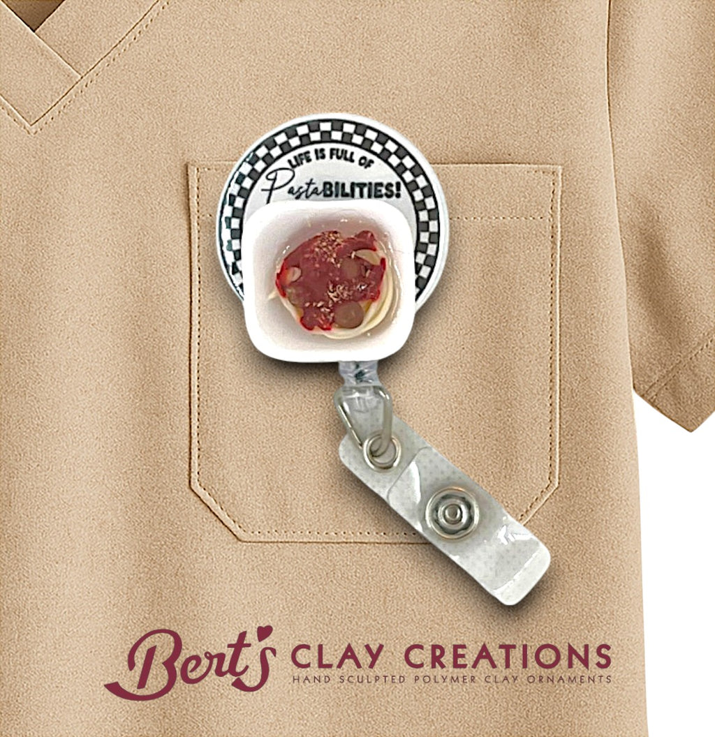 Badge holder with a clay ornament on a beige background, featuring 'Bert's Clay Creations' branding.
