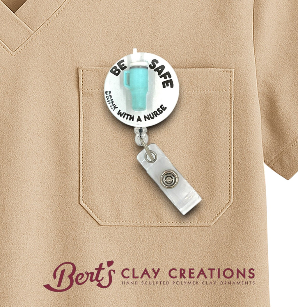 Badge holder with 'Be Safe, Work With a Nurse' message on a beige shirt, featuring Bert's Clay Creations logo.