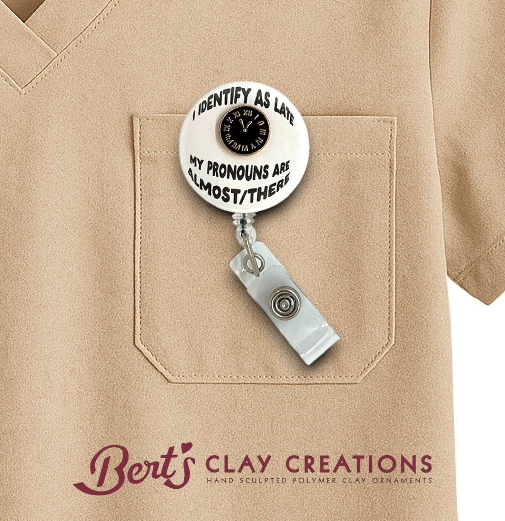 Badge holder with a message on a beige shirt, featuring the brand 'Bert's Clay Creations'.