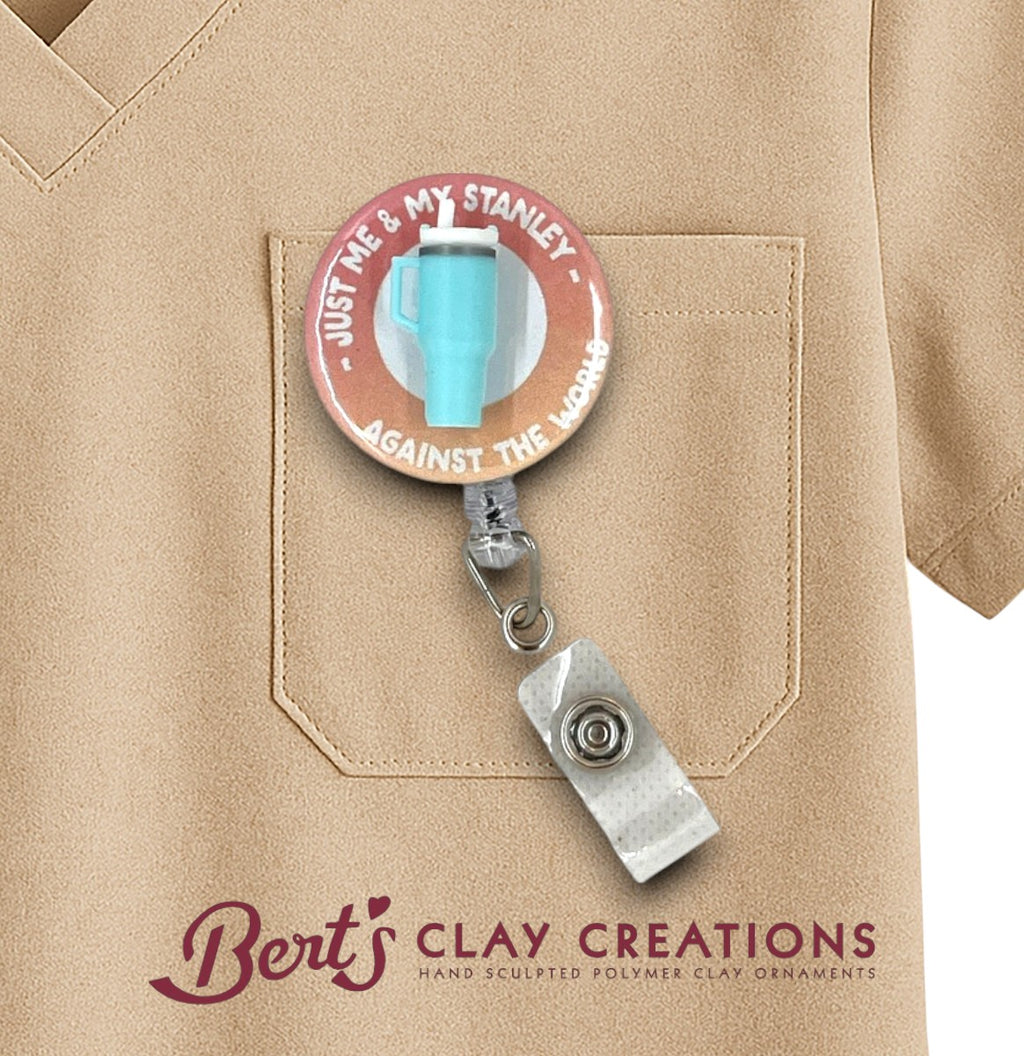 Retractable badge holder with 'Just Me & My Stanley Against the World' design on a tan shirt, featuring Bert's Clay Creations branding.