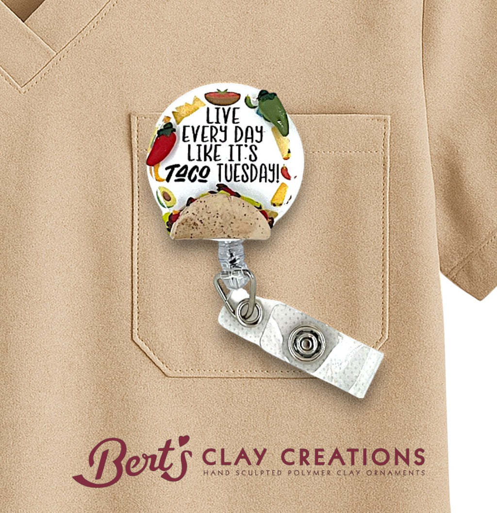 Badge holder with 'Live Every Day Like It's Taco Tuesday' design on a beige shirt, featuring the brand 'Bert's Clay Creations'.